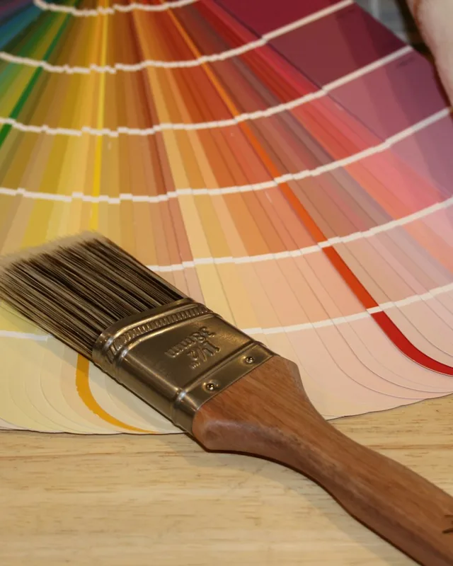 Paint colour fan deck with a paint brush